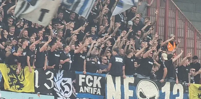 Geviseerde Club Brugge-fans reageren en wijzen naar Standard